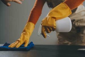 Office Cleaning Service. Janitor Spraying Desk. Workplace Hygiene photo