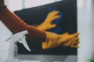 Office Cleaning Service. Janitor Spraying Desk. Workplace Hygiene photo