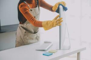 Office Cleaning Service. Janitor Spraying Desk. Workplace Hygiene photo