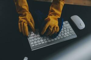 Office Cleaning Service. Janitor Spraying Desk. Workplace Hygiene photo