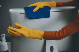 Office Cleaning Service. Janitor Spraying Desk. Workplace Hygiene photo