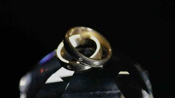 bruiloft ringen aan het liegen Aan kristal schijnend met licht dichtbij omhoog macro video