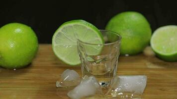 Man puts a glass then fills it with vodka or tequila and picks up a glass video