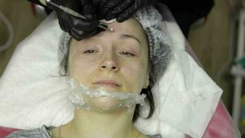 Cosmetologist make facial cleaning cosmetology skin acne procedure on woman face video