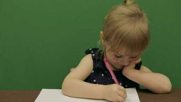 Girl sitting at the table. Education process. Cute girl smiling. Chroma Key video