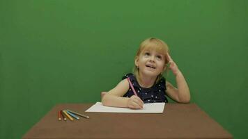 Girl sitting at the table. Education process. Cute girl smiling. Chroma Key video
