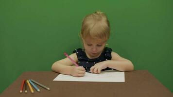 Girl sitting at the table. Education process. Cute girl smiling. Chroma Key video