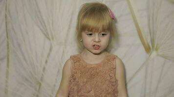 Happy three years old girl make faces and dancing. Cute blonde child video