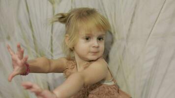 Happy three years old girl make faces and dancing. Cute blonde child video