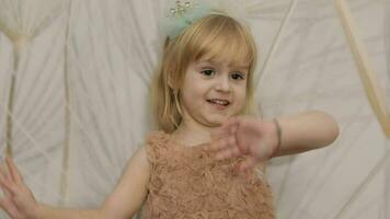 Happy three years old girl make faces and dancing. Cute blonde child video