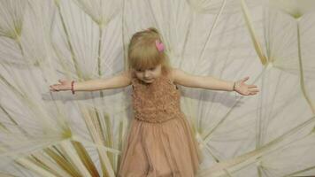 Happy three years old girl make faces and dancing. Cute blonde child video