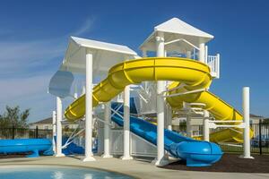 ai generado hermosa ver de agua parque con vistoso diapositivas y nadando piscina en soleado día. neural red ai generado foto