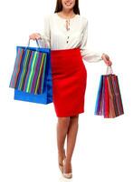 Pretty woman with shopping bags. Isolated photo