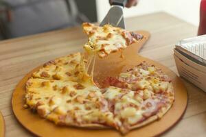 hawaiian pizza serve on wood tray with side dish Lasagna , spaghett , cheese ball photo