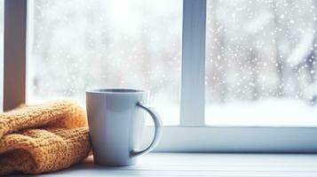 AI generated Winter holidays, calm and cosy home, cup of tea or coffee mug and knitted blanket near window in the English countryside cottage, holiday atmosphere photo