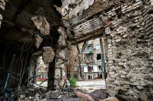 destroyed and burned houses in the city during the war in Ukraine photo
