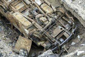 burnt cars and destroyed buildings of the workshop of the Azovstal plant in Mariupol photo