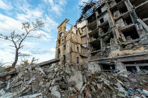 destroyed and burned houses in the city during the war in Ukraine photo