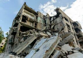 destroyed and burned houses in the city during the war in Ukraine photo