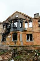 destroyed and burned houses in the city during the war in Ukraine photo