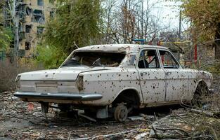 damaged and looted cars in a city in Ukraine during the war photo