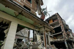 destroyed and burned houses in the city during the war in Ukraine photo