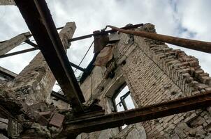 destroyed and burned houses in the city during the war in Ukraine photo