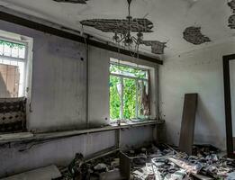 inside a destroyed house without people in an abandoned city in Ukraine photo