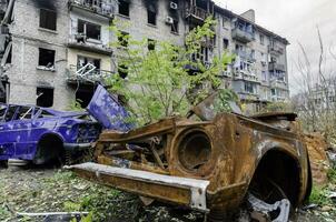 damaged and looted cars in a city in Ukraine during the war photo