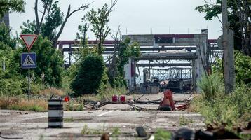 burnt cars and destroyed buildings of the workshop of the Azovstal plant in Mariupol photo