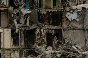 destroyed and burned houses in the city during the war in Ukraine photo