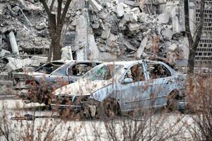 damaged and looted cars in a city in Ukraine during the war photo