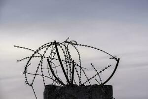 barbed wire fence against the sky in Ukraine photo