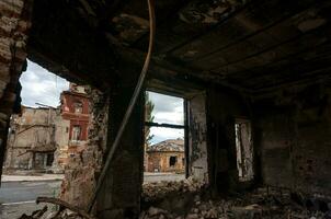 destroyed and burned houses in the city during the war in Ukraine photo