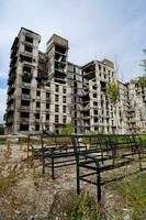 destroyed and burned houses in the city during the war in Ukraine photo