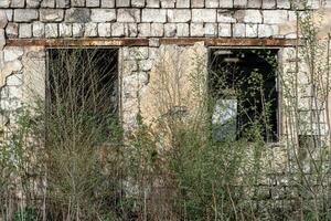 empty windows of a damaged house in Ukraine photo