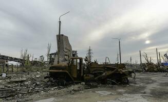 burnt cars and destroyed buildings of the workshop of the Azovstal plant in Mariupol photo