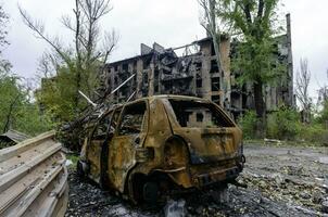 damaged and looted cars in a city in Ukraine during the war photo