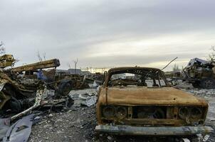 burnt cars and destroyed buildings of the workshop of the Azovstal plant in Mariupol photo