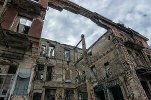 destroyed and burned houses in the city during the war in Ukraine photo