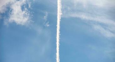 contrail of a rocket launch in the blue sky in Ukraine photo
