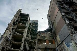 destroyed and burned houses in the city during the war in Ukraine photo