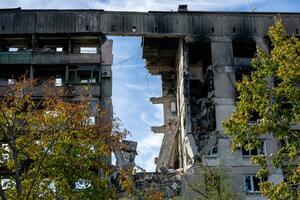 destroyed and burned houses in the city during the war in Ukraine photo