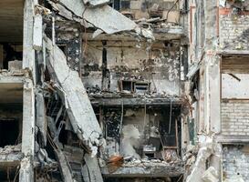 destroyed and burned houses in the city during the war in Ukraine photo