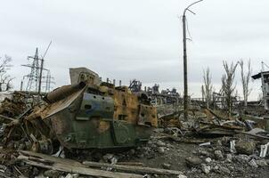 burnt tank and destroyed buildings of the Azovstal plant shop in Mariupol photo