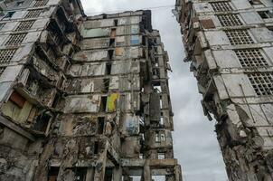 destroyed and burned houses in the city during the war in Ukraine photo