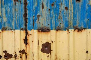 damaged blue yellow house wall war in Ukraine photo