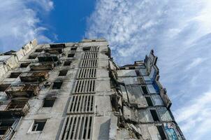 destroyed and burned houses in the city during the war in Ukraine photo