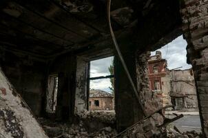 destroyed and burned houses in the city during the war in Ukraine photo