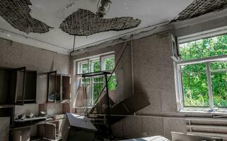 inside a destroyed house without people in an abandoned city in Ukraine photo